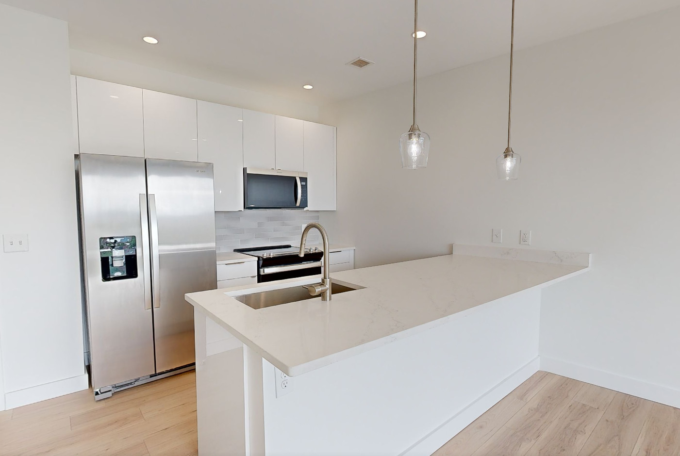 Modern white kitchen with island, stainless steel appliances