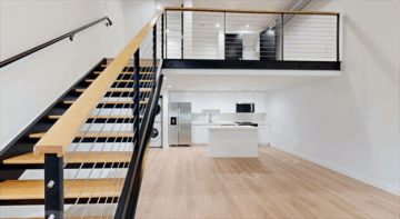 Modern loft with staircase and open kitchen.