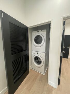 Stacked washer and dryer in small closet.