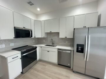 Modern kitchen with stainless steel appliances.