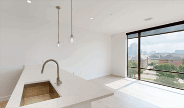 Modern apartment kitchen with large windows and city view
