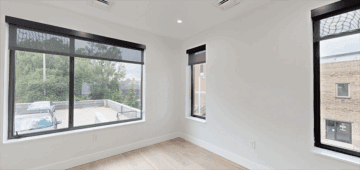 Bright empty room with large windows, modern interior, natural light, downtown view, The 616 Chicago.
