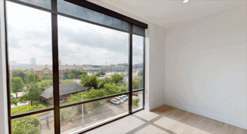 Bright room with large window and city view.