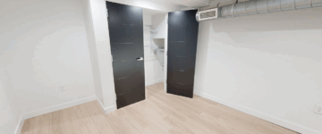 Empty closet with open black doors
