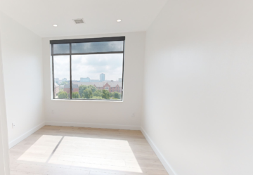 Person writing in notebook with laptop and coffee nearby