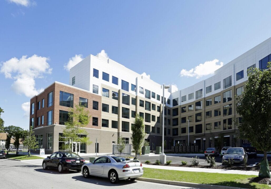 Modern apartment building with parked cars