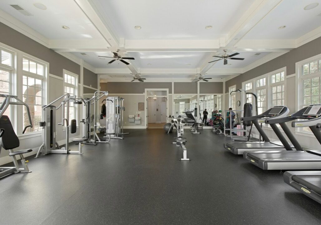 Spacious gym with modern exercise equipment.