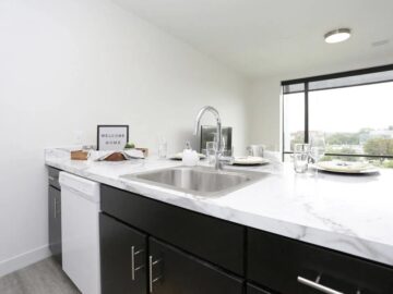 Modern kitchen with marble countertop and city view