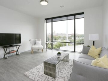 Modern apartment living room with floor-to-ceiling windows