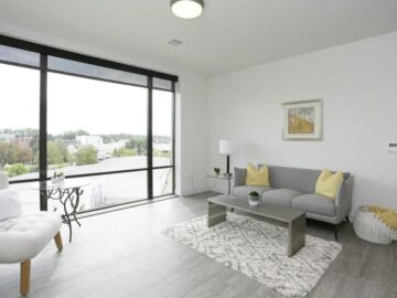 Modern bright living room with floor-to-ceiling windows and city view