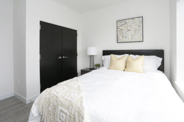 Modern bedroom with black headboard and white bedding