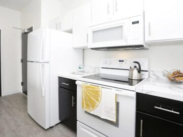 Modern kitchen with white appliances and black cabinets